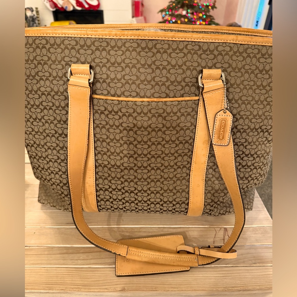 Coach duffle with zipper and interior pockets.